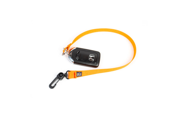 A 16-inch Zest (orange) Key Strap with a snaphook at one end and a split-ring o-ring at the other.